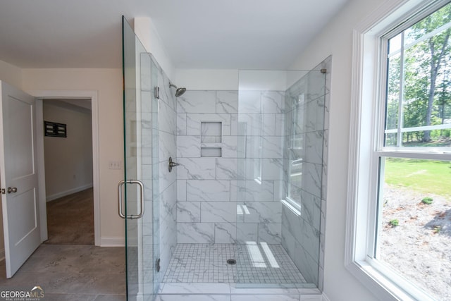 bathroom featuring a shower with door