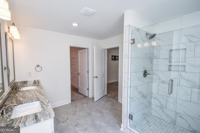 bathroom featuring walk in shower, tile patterned flooring, and double sink vanity