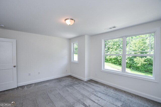 unfurnished room with light carpet