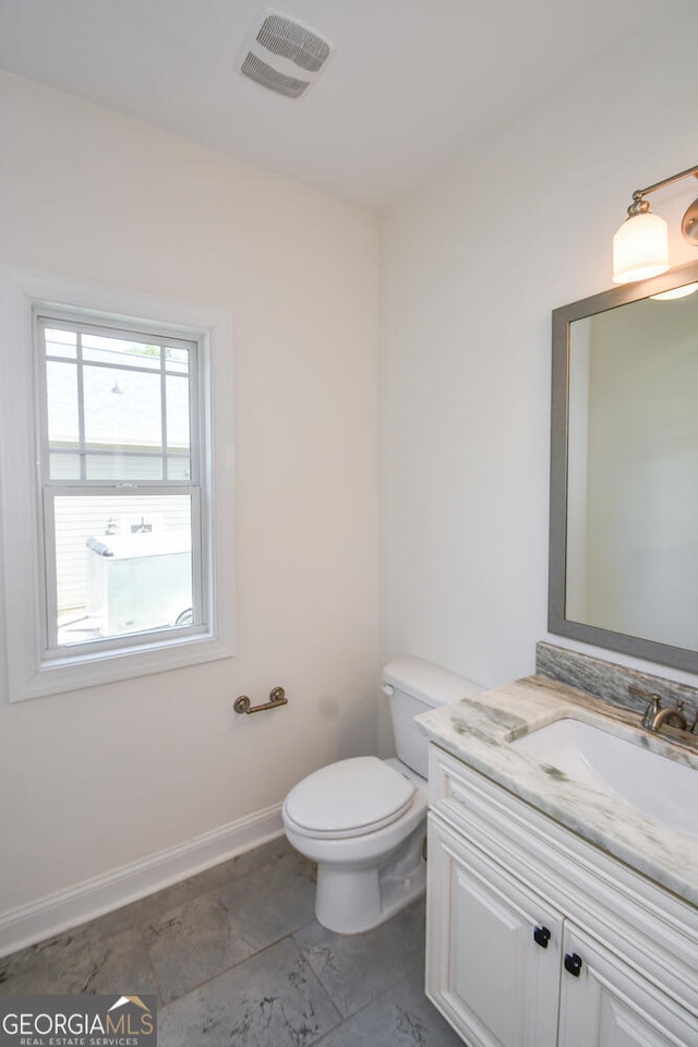 bathroom with vanity and toilet