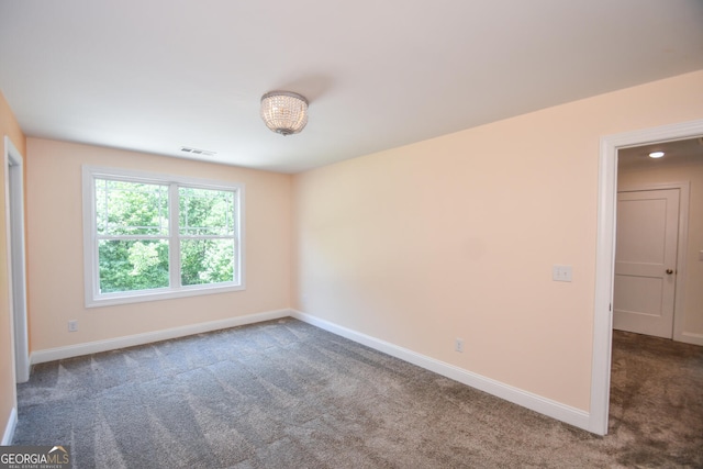 empty room with dark colored carpet