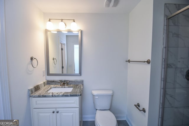 bathroom featuring vanity, toilet, and a shower with shower door