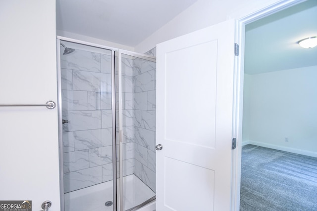 bathroom with a shower with door