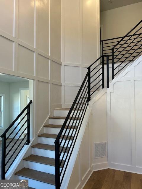 stairway featuring wood-type flooring