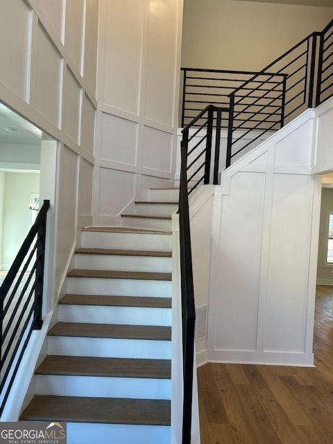 stairway with hardwood / wood-style flooring