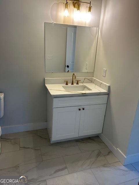 bathroom with vanity and toilet