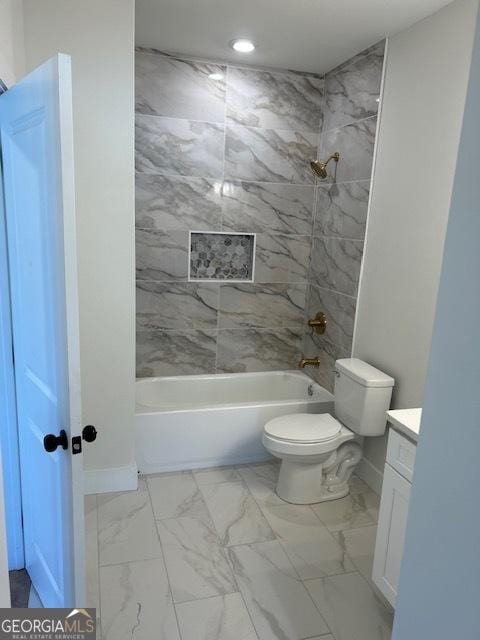 full bathroom featuring vanity, toilet, and tiled shower / bath