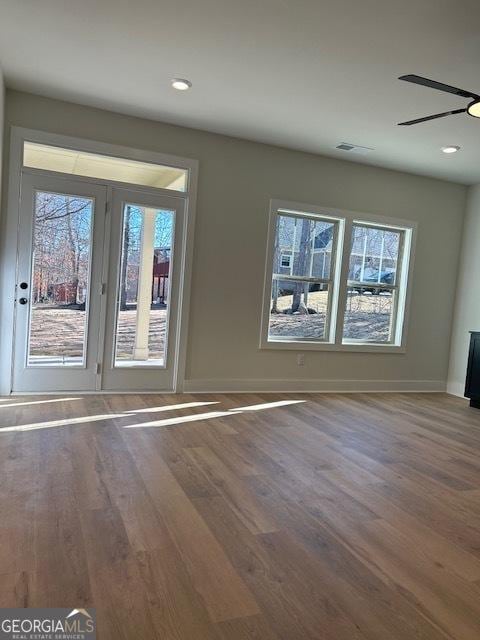 unfurnished room with hardwood / wood-style flooring and ceiling fan