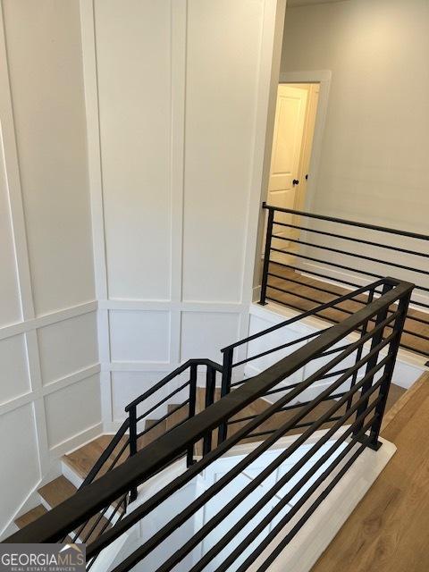 stairs featuring hardwood / wood-style flooring