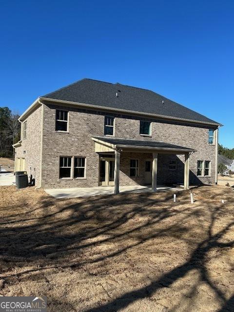 rear view of house featuring central air condition unit and a patio