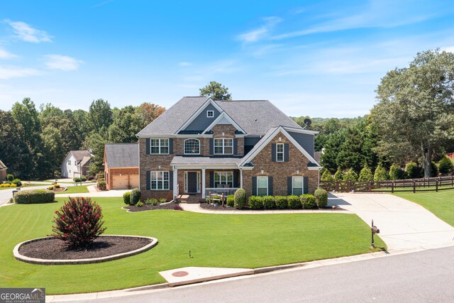 craftsman-style house featuring a front lawn and a garage