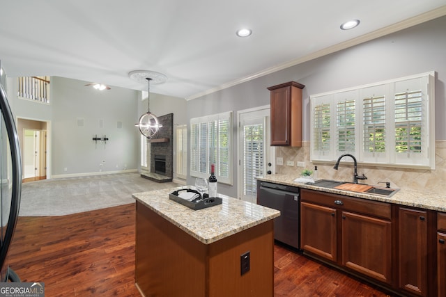 kitchen featuring light stone counters, dark wood-type flooring, dishwasher, tasteful backsplash, and a kitchen island