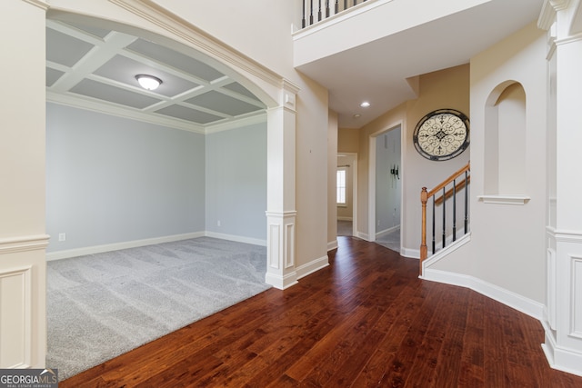 foyer featuring coffered ceiling, crown molding, decorative columns, wood-type flooring, and beam ceiling