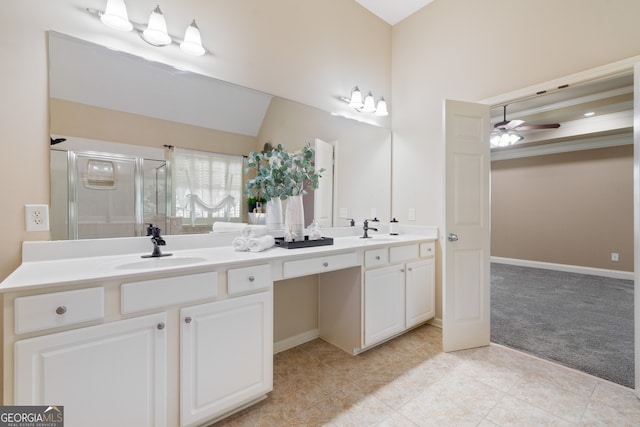 bathroom featuring ceiling fan, dual bowl vanity, a shower with door, and tile patterned flooring