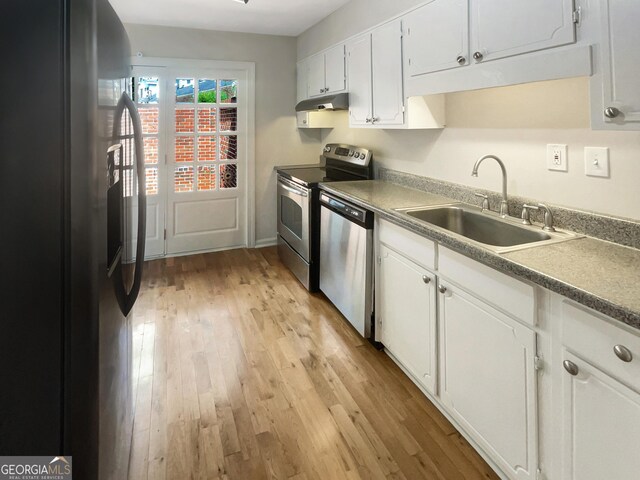 kitchen featuring light wood-type flooring, stainless steel dishwasher, black fridge with ice dispenser, and electric range oven