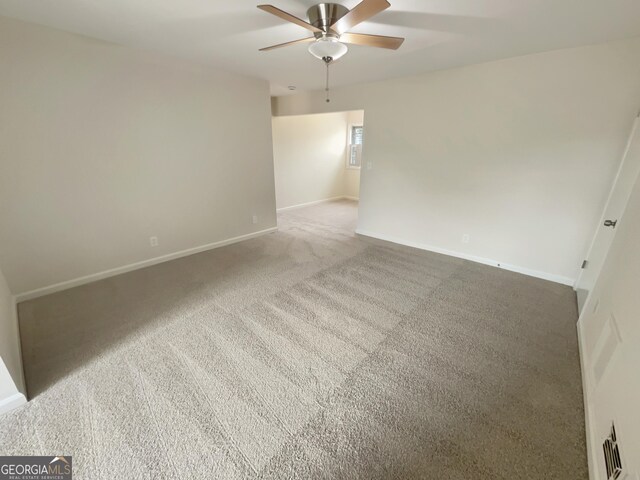 spare room with carpet and ceiling fan