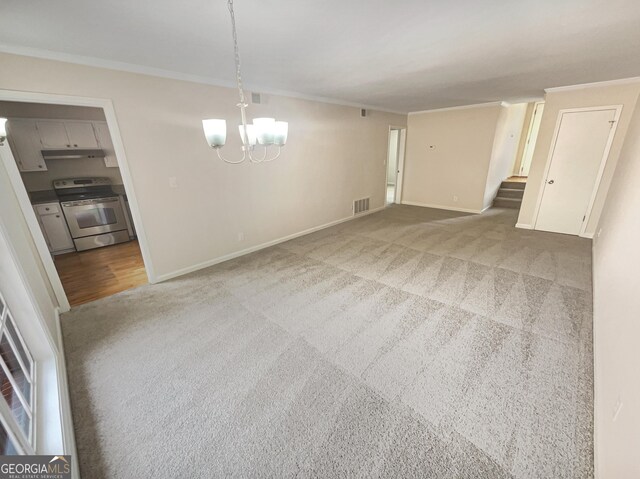 unfurnished dining area featuring an inviting chandelier, ornamental molding, and light colored carpet