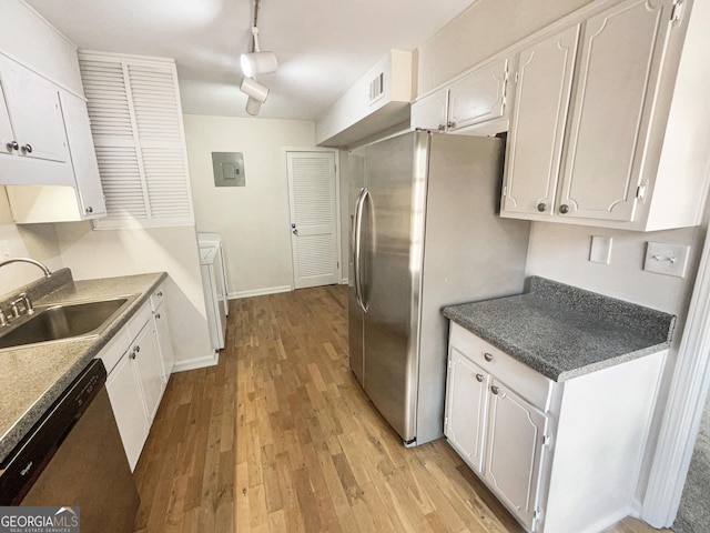 kitchen with white cabinets, track lighting, and light hardwood / wood-style flooring