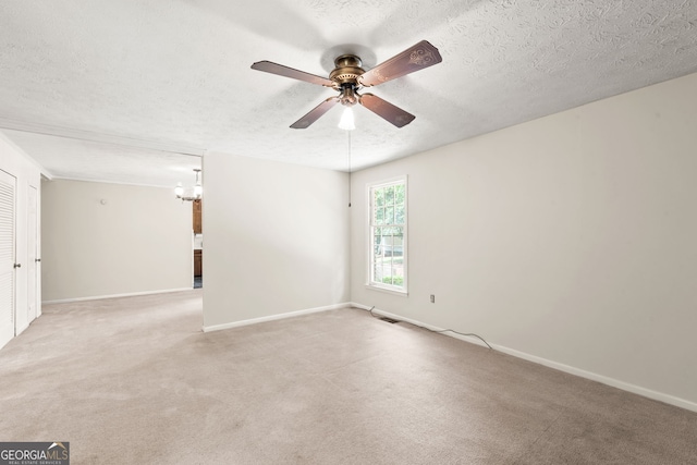 carpeted empty room featuring a textured ceiling and ceiling fan