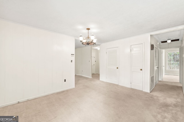 unfurnished bedroom with an inviting chandelier, light colored carpet, and crown molding