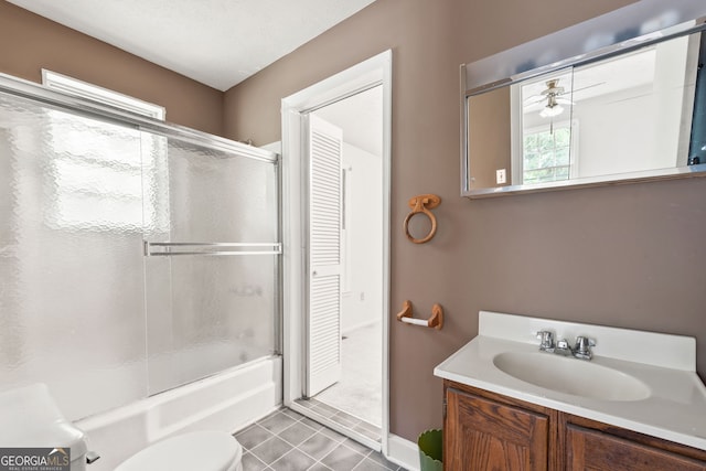 full bathroom with tile patterned floors, toilet, vanity, and enclosed tub / shower combo