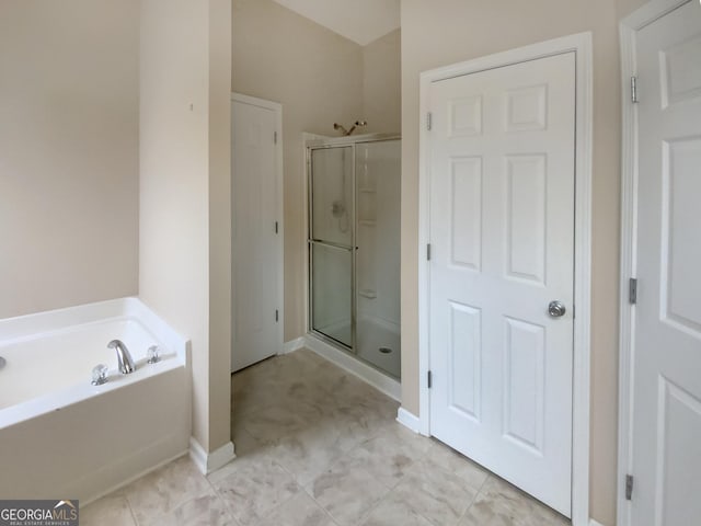 bathroom featuring plus walk in shower and tile patterned floors