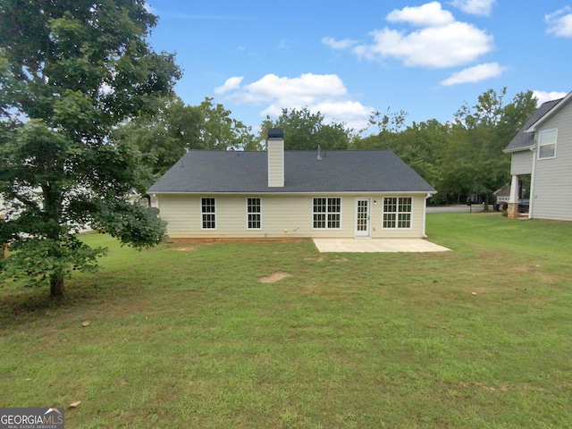 back of property with a patio and a lawn