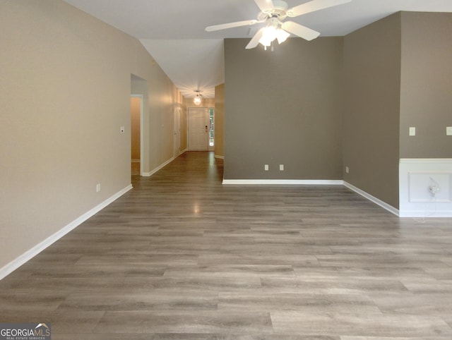 empty room with vaulted ceiling, light hardwood / wood-style floors, and ceiling fan