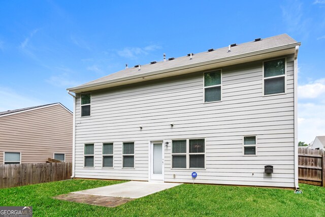 back of property with a patio and a lawn