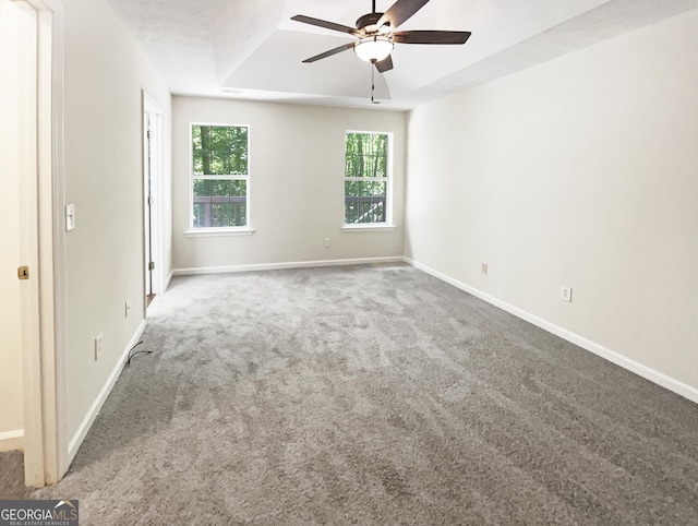 carpeted spare room featuring ceiling fan