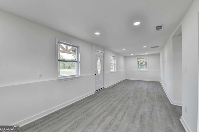 unfurnished room with plenty of natural light and hardwood / wood-style floors