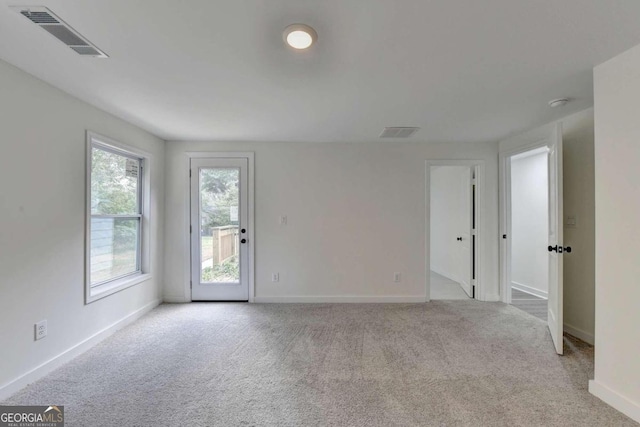 empty room featuring light colored carpet