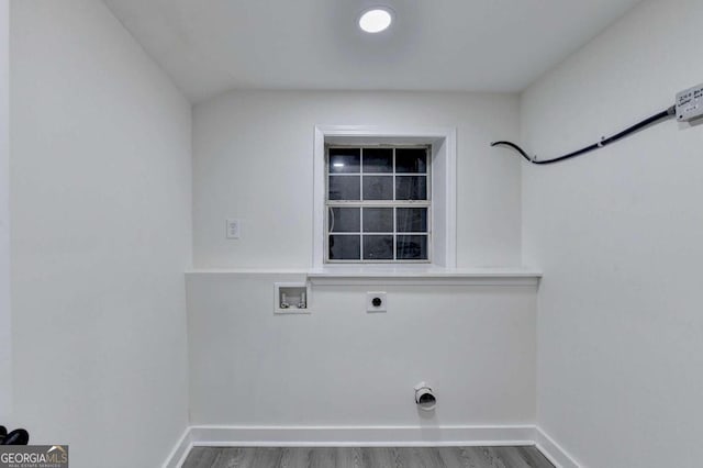 clothes washing area with wood-type flooring, hookup for an electric dryer, and washer hookup