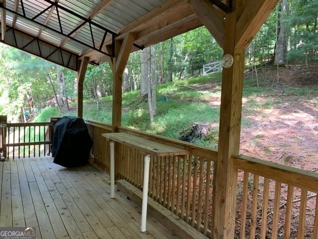 wooden deck featuring area for grilling