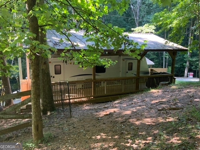 view of property exterior with a deck