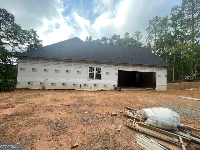 rear view of property featuring a garage