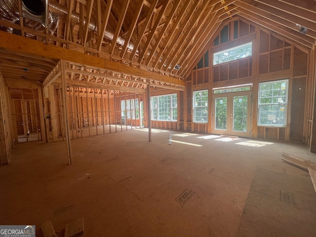 miscellaneous room featuring high vaulted ceiling and french doors