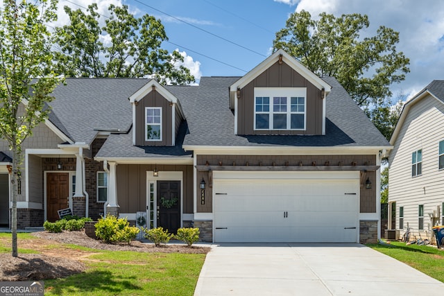 craftsman inspired home featuring covered porch, a garage, and a front lawn