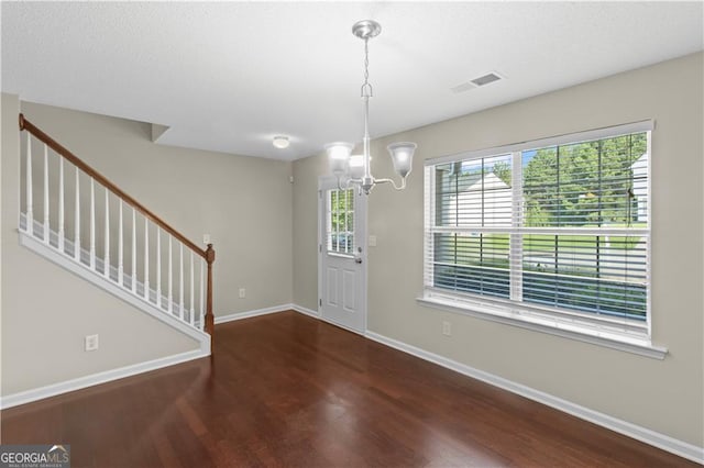 foyer featuring a notable chandelier and hardwood / wood-style floors