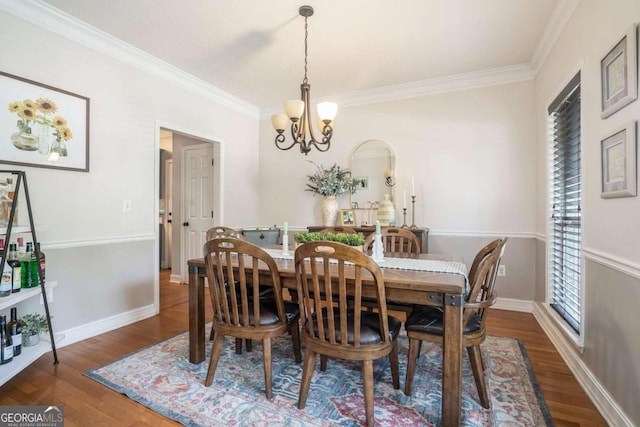 dining space with crown molding, dark hardwood / wood-style flooring, and a notable chandelier