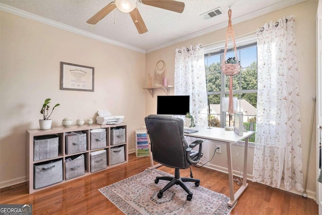 home office featuring crown molding, dark hardwood / wood-style flooring, ceiling fan, and a textured ceiling