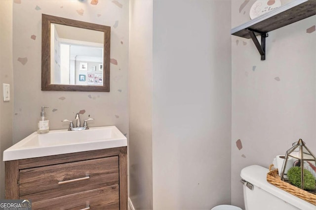 bathroom with toilet and vanity