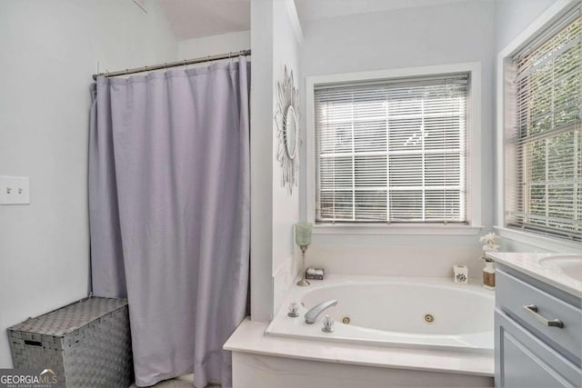 bathroom featuring a tub to relax in and vanity