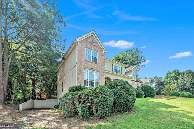 view of property exterior featuring a lawn