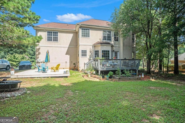 rear view of property with a lawn and a deck