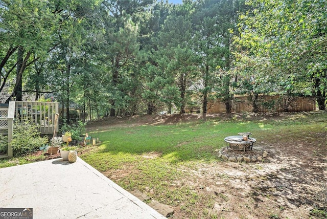 view of yard featuring an outdoor fire pit and a wooden deck