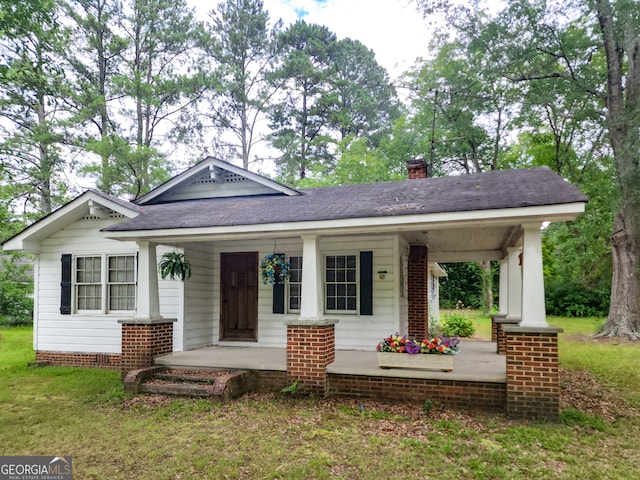 view of front of home with a front lawn and a porch