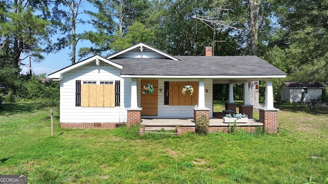 view of front of property featuring crawl space, covered porch, a chimney, and a front lawn