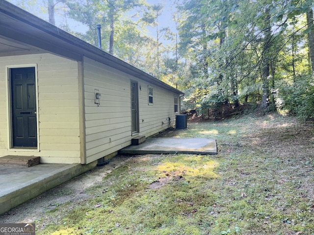 view of side of home with cooling unit and a patio area