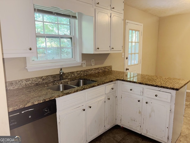 kitchen with sink, dishwasher, dark stone counters, kitchen peninsula, and white cabinets